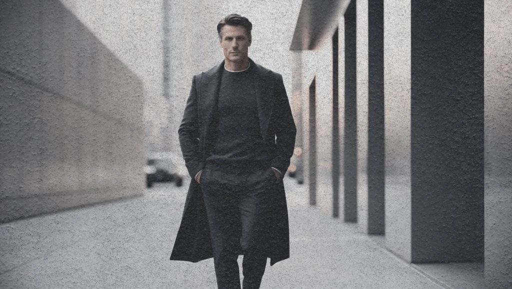 Confident man in relaxed tailored outfit walking in city